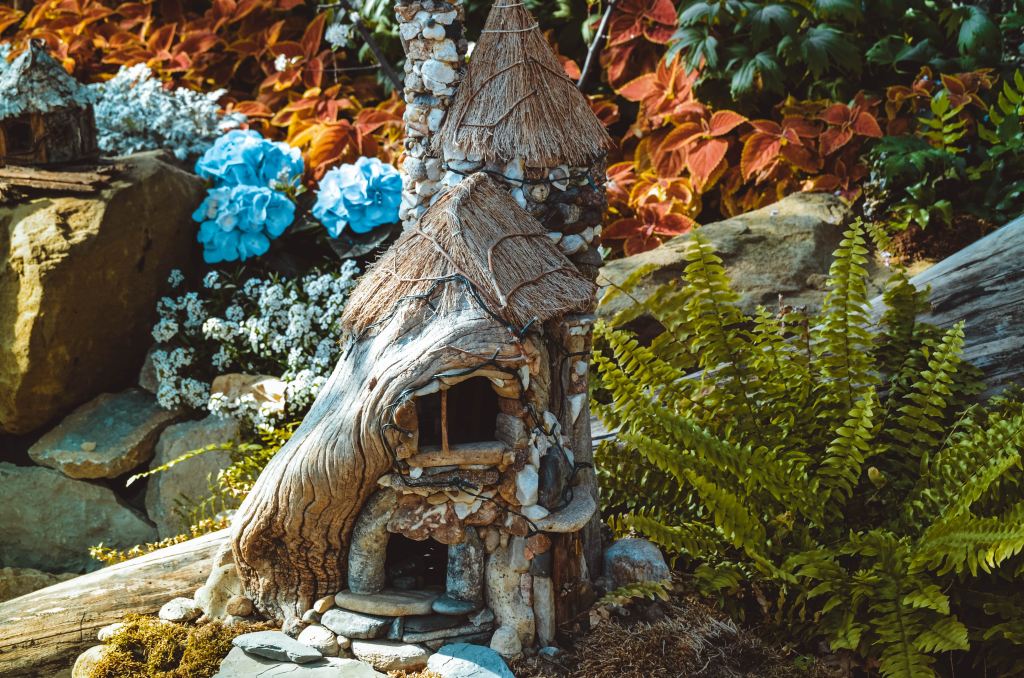 A photo of a tiny fairy house in a garden.
